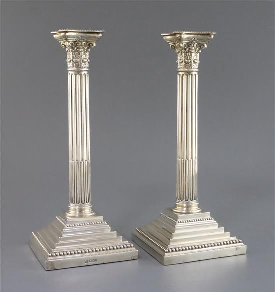 A pair of Edwardian silver corinthian column candlesticks, W.W. Harrison & Co, 19.5cm.